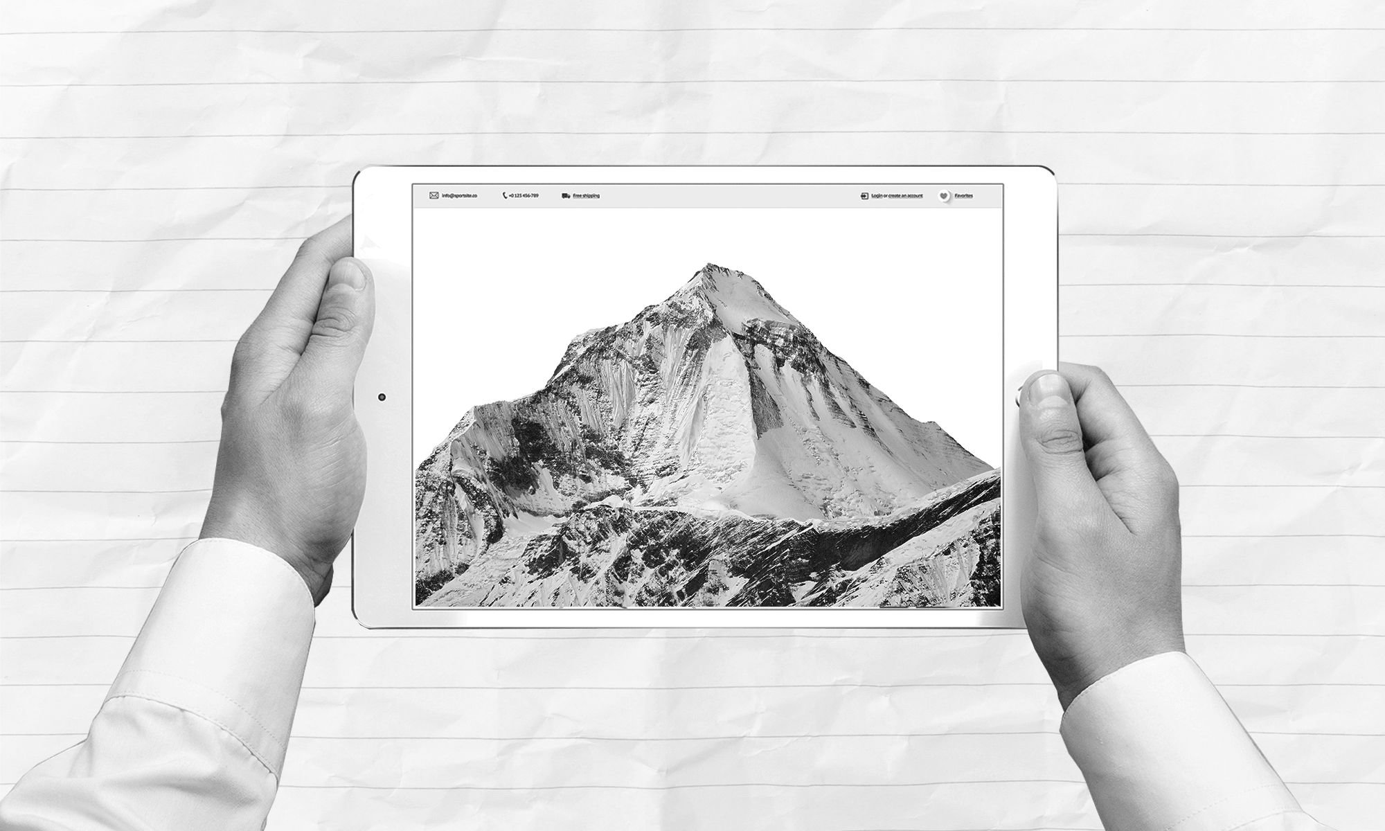 A pair of hands holding a tablet with a mountain image on the screen.