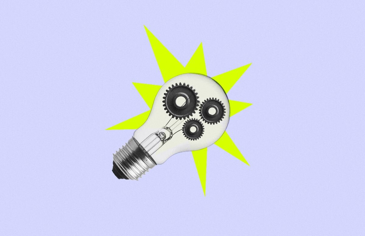 Light bulb with gears inside on a starburst background.