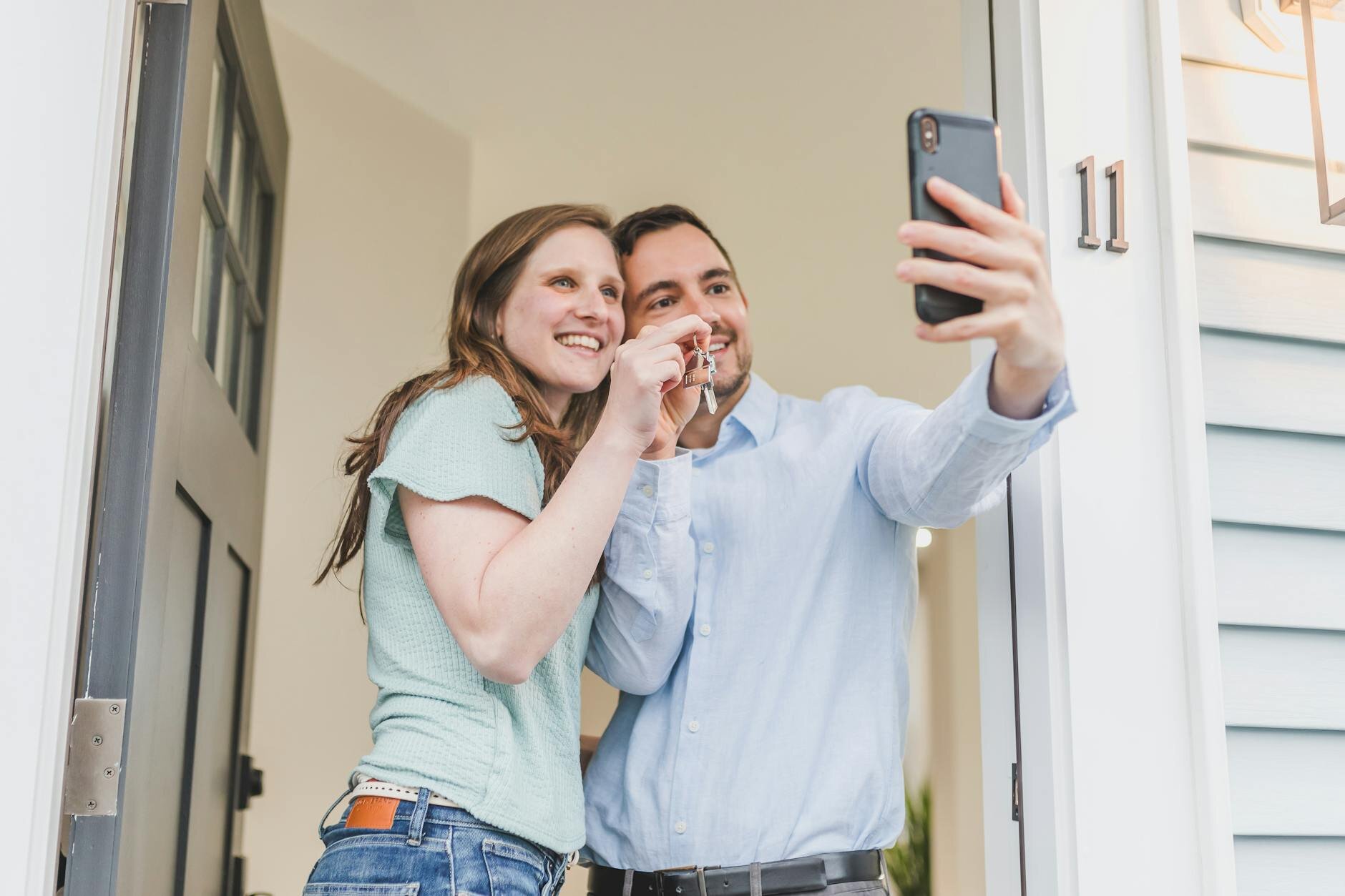 Couple taking a selfie while moving into their first home.