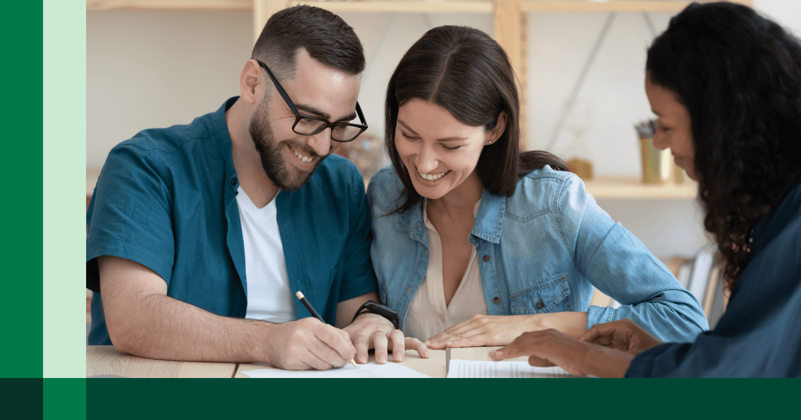 Two Persons Signing Document and Smiling with Another Person Overseeing