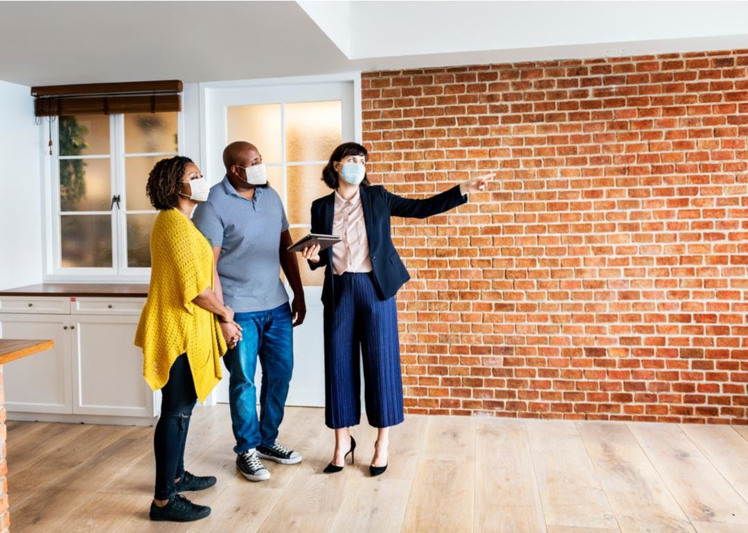 “Photograph of a couple getting a tour of a home listing from a real estate agent” - Source:Rawpixel.com // Shutterstock