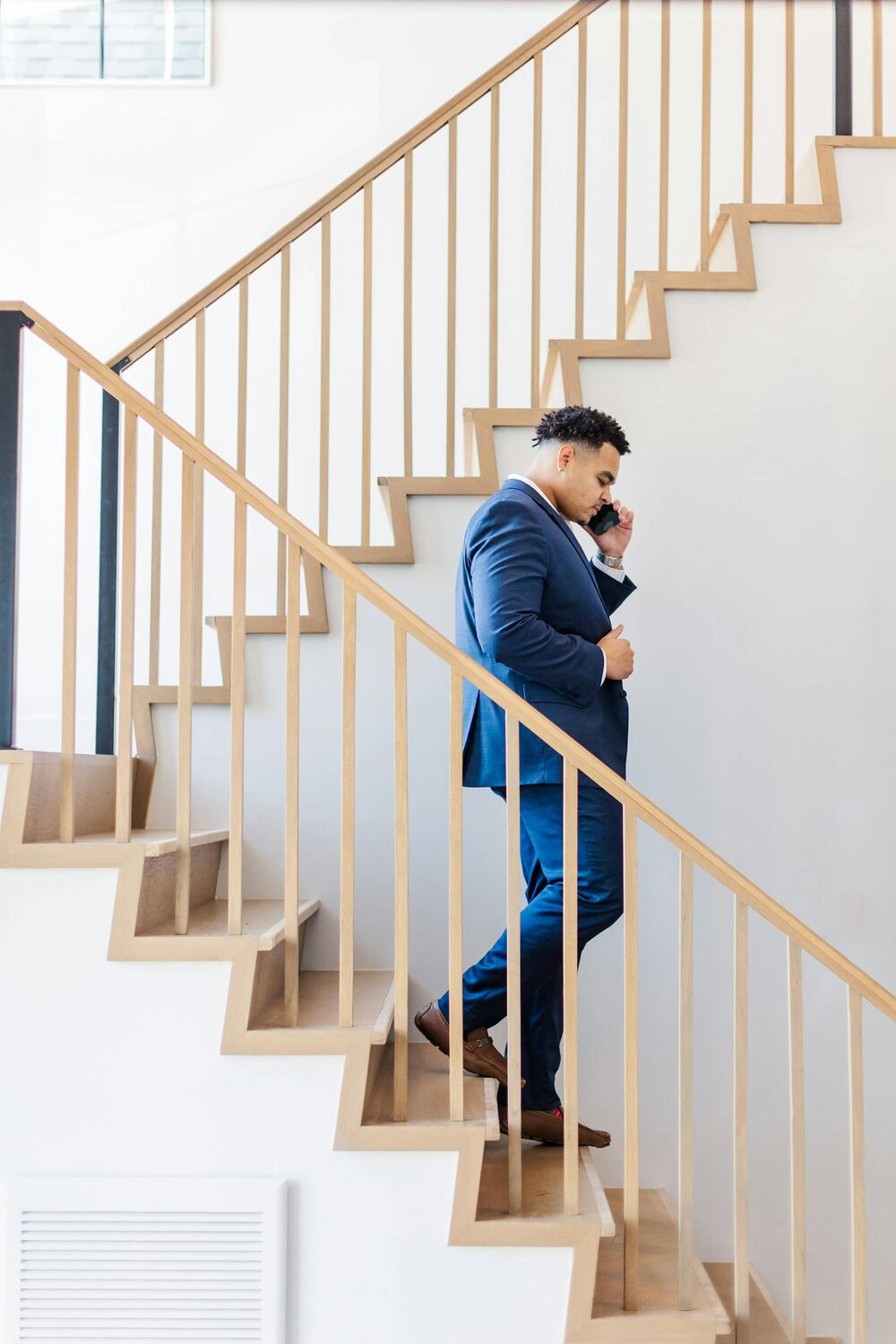 Quincy walking down stairs on cellphone