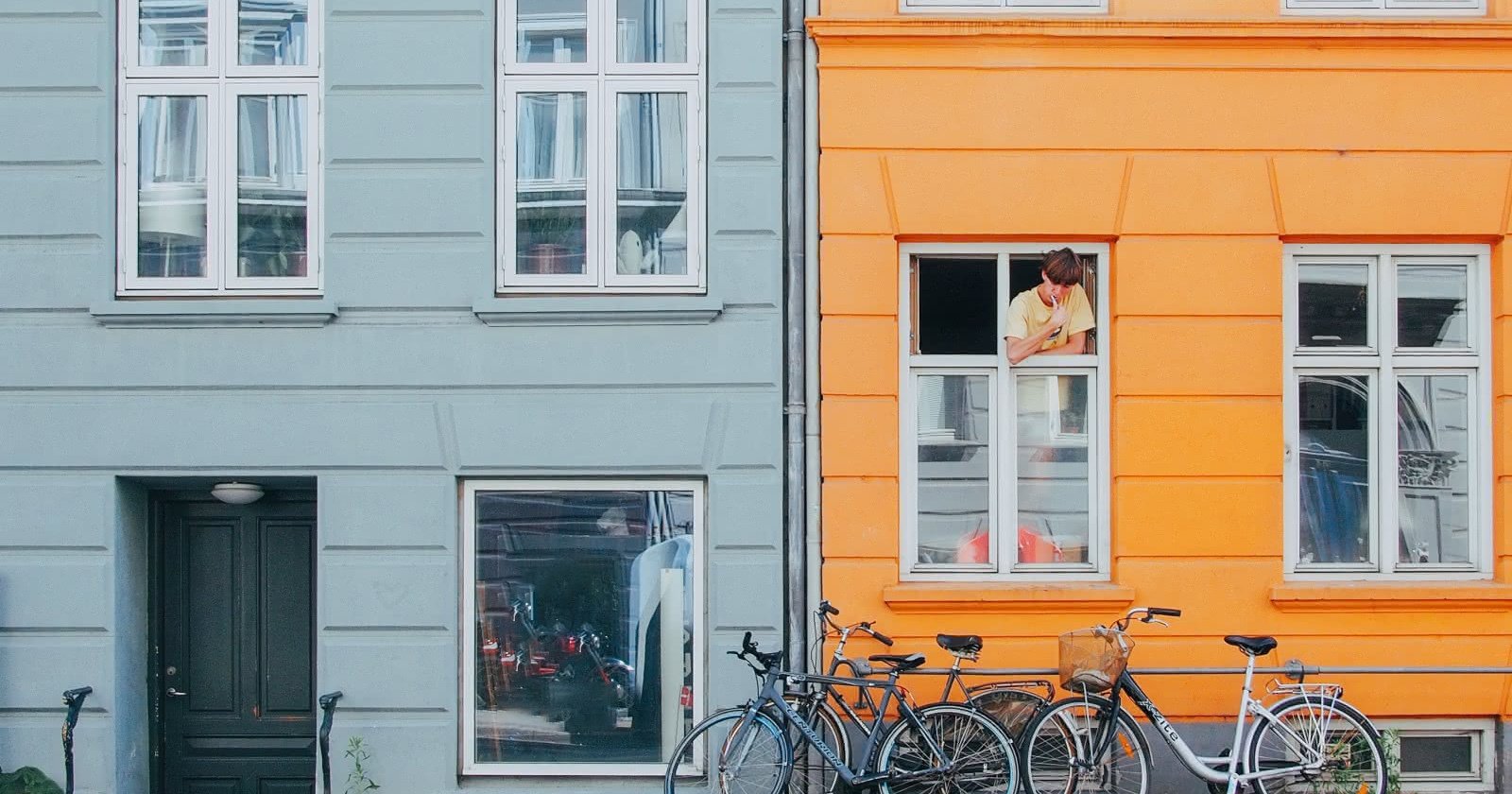 person in window looking at bikes