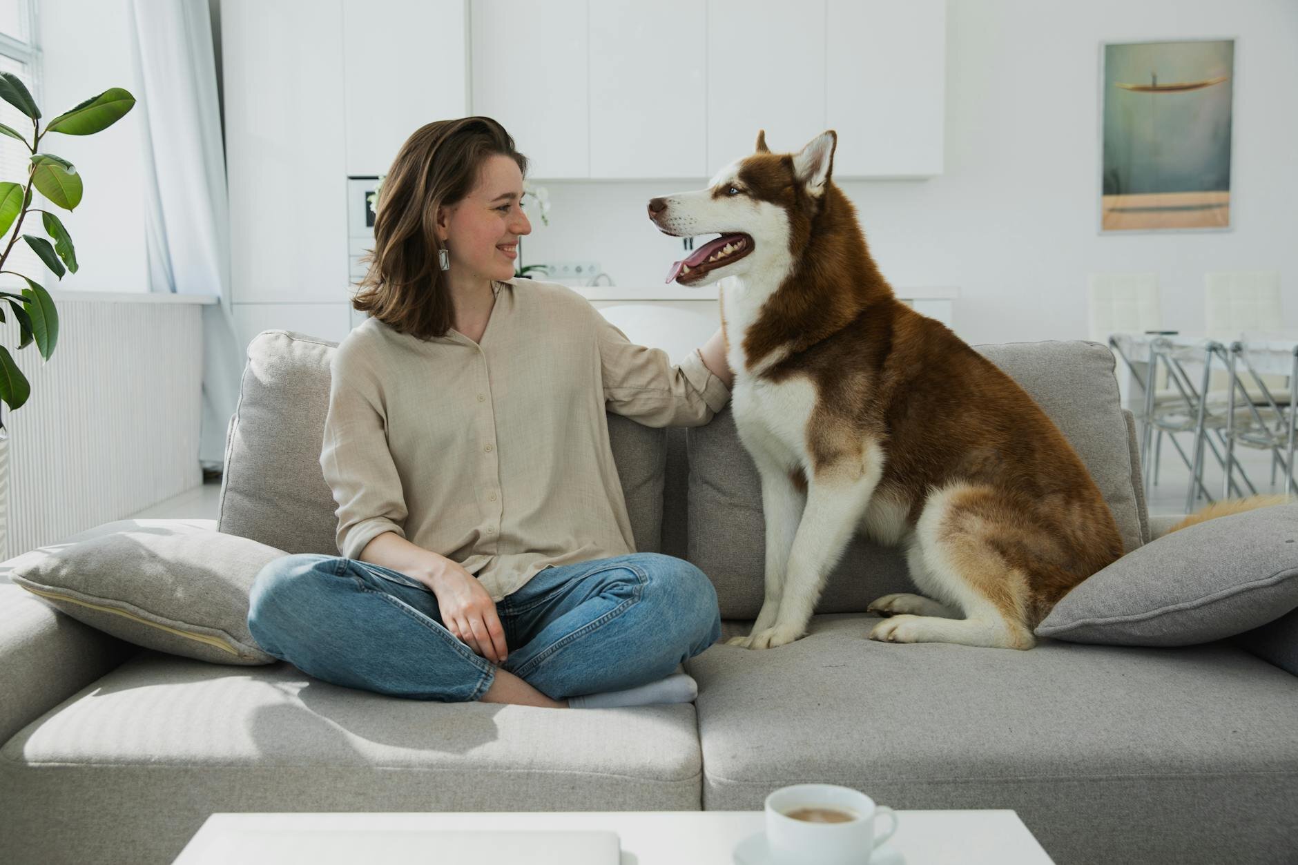 Woman smiling at her dog after realizing the income needed for a $600k mortgage