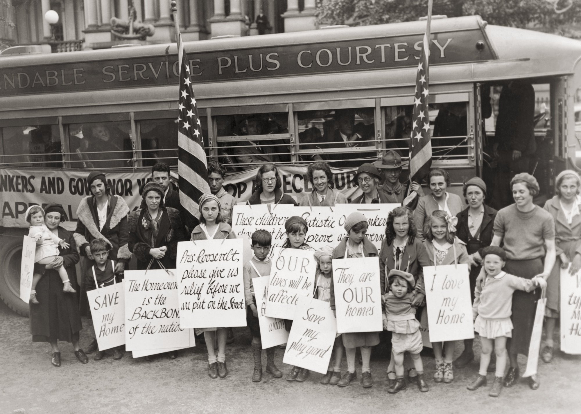 Photograph of protestors holding signs asking for mortgage relief - Bettmann // Getty Images