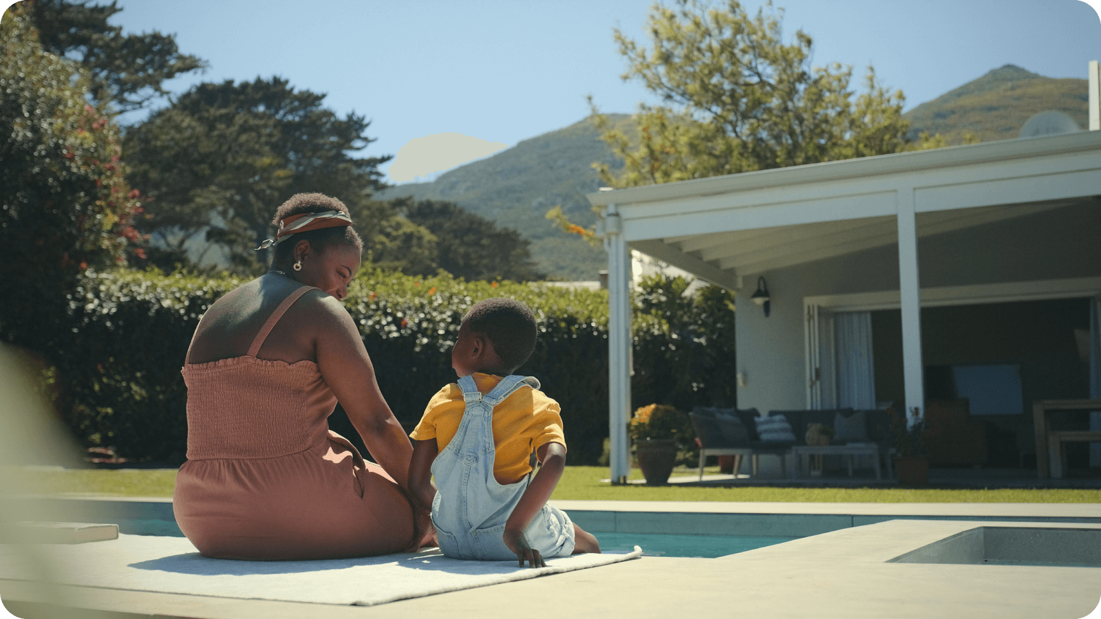 Family relaxing by the pool at their home after navigating refinancing requirements