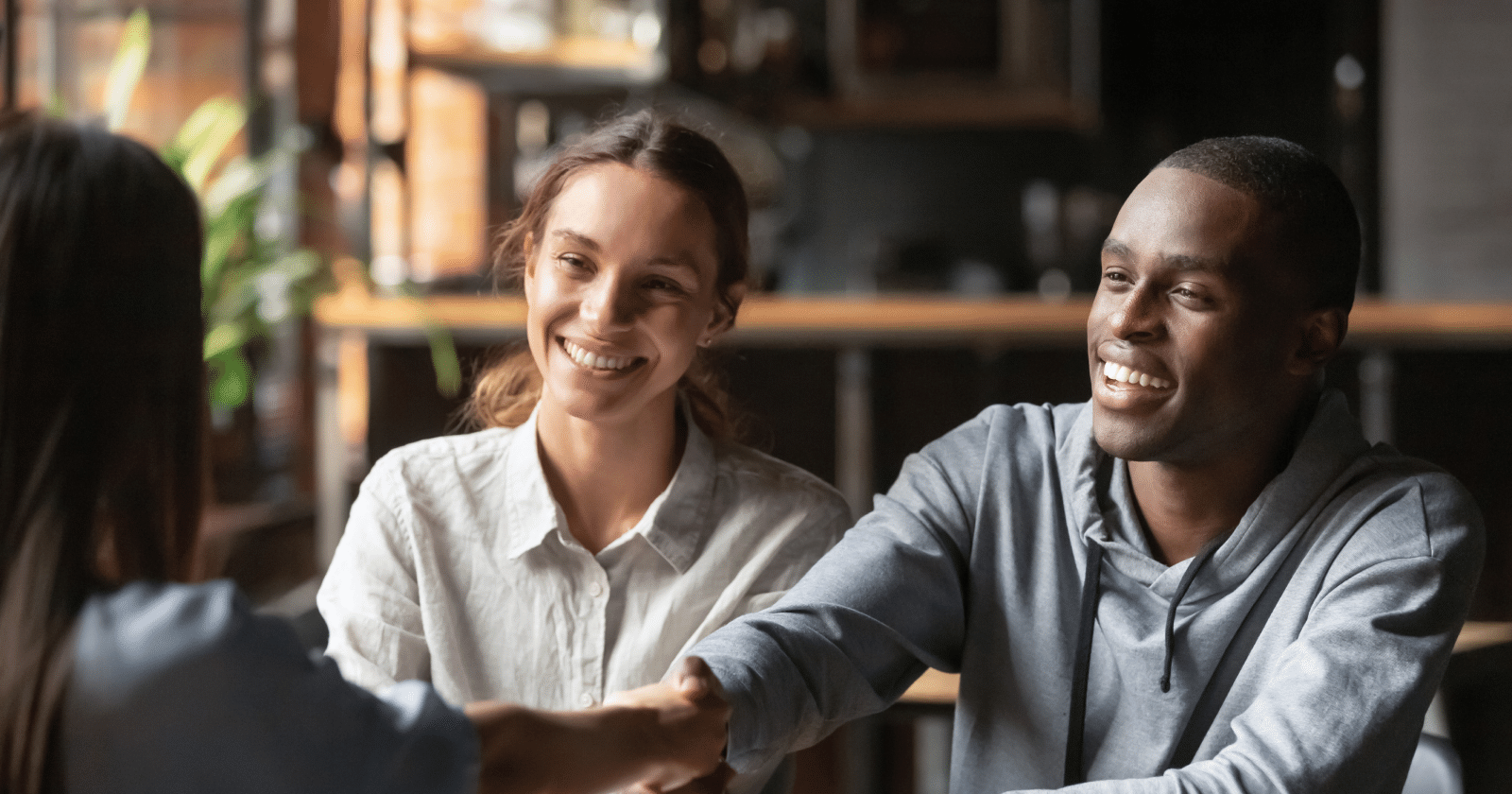 People Shaking Hands and Smiling