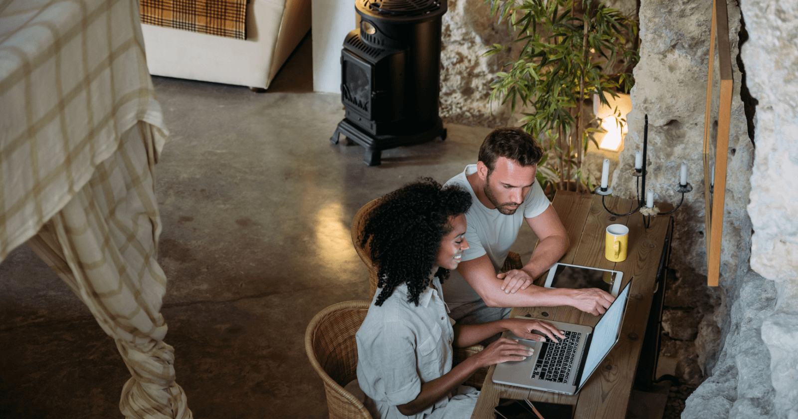 Top Down View of Two Persons Discussing Something They See on a Laptop