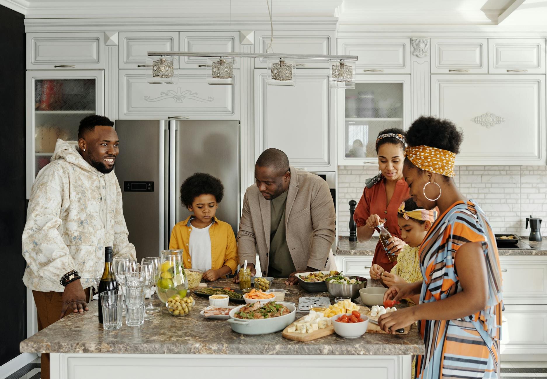 Family preparing a meal in their kitchen after learning the differences between second mortgage and home equity loans.