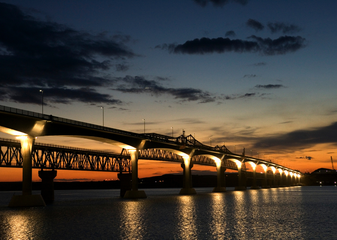 “Photograph of an illuminated bridge at sunset” - Source: Canva