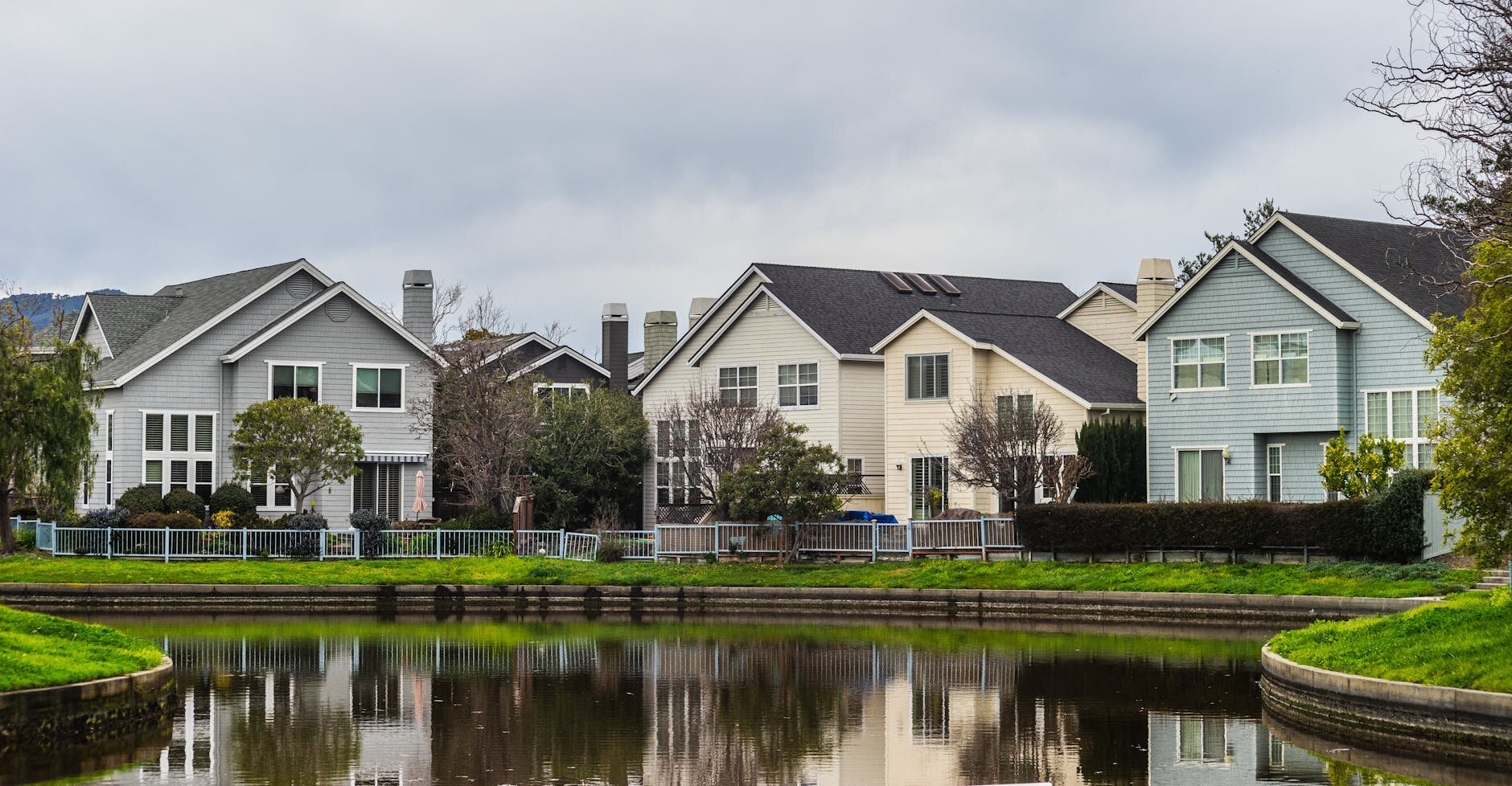 Home sitting near peaceful water after a successful purchase process despite credit score turbulence