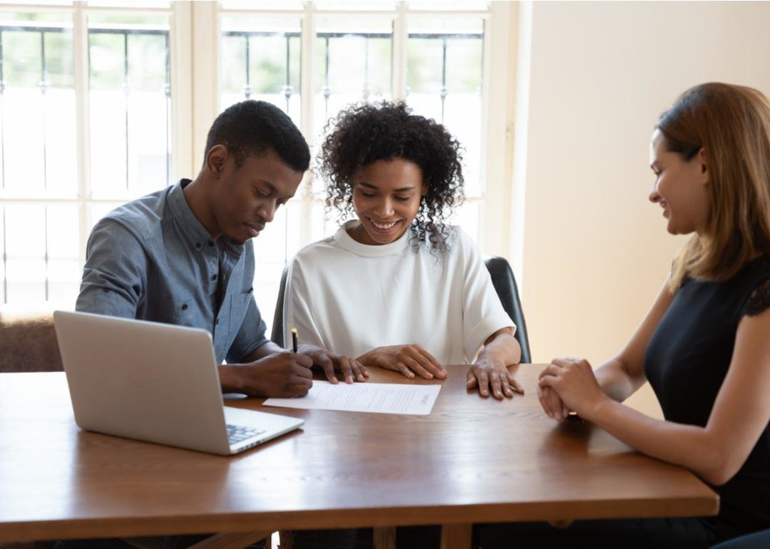 “Photograph of a couple signing mortgage paperwork” - Source: fizkes // Shutterstock