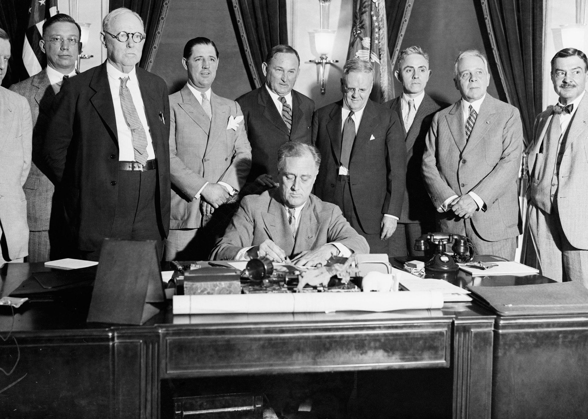 Photograph of President Franklin D. Roosevelt signing legislation related to the New Deal - Bettmann // Getty Images
