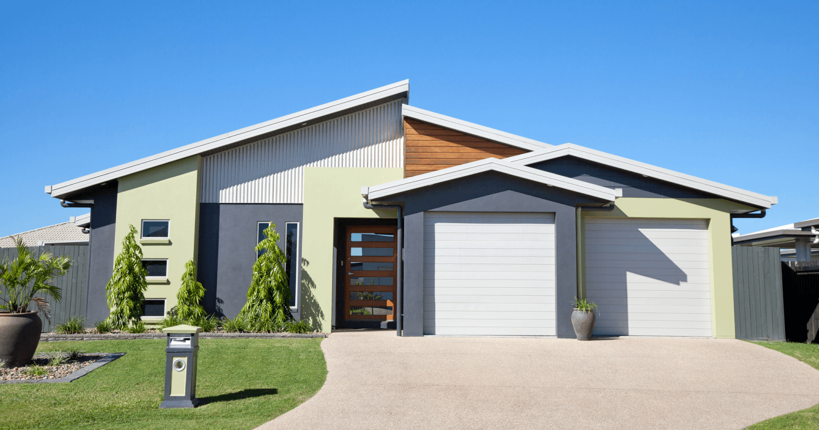 Modern Style Light Green and Grey Home Against Blue Sky