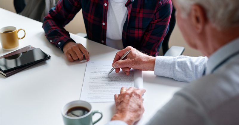 Two People at a Desk Reviewing Paperwork