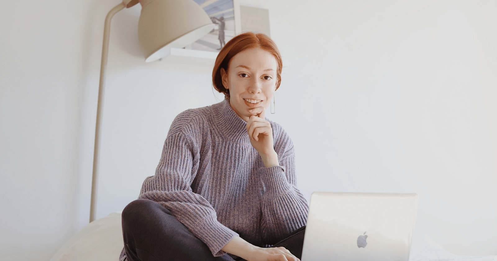 Image of Person in Minimal Setting with Laptop Smiling