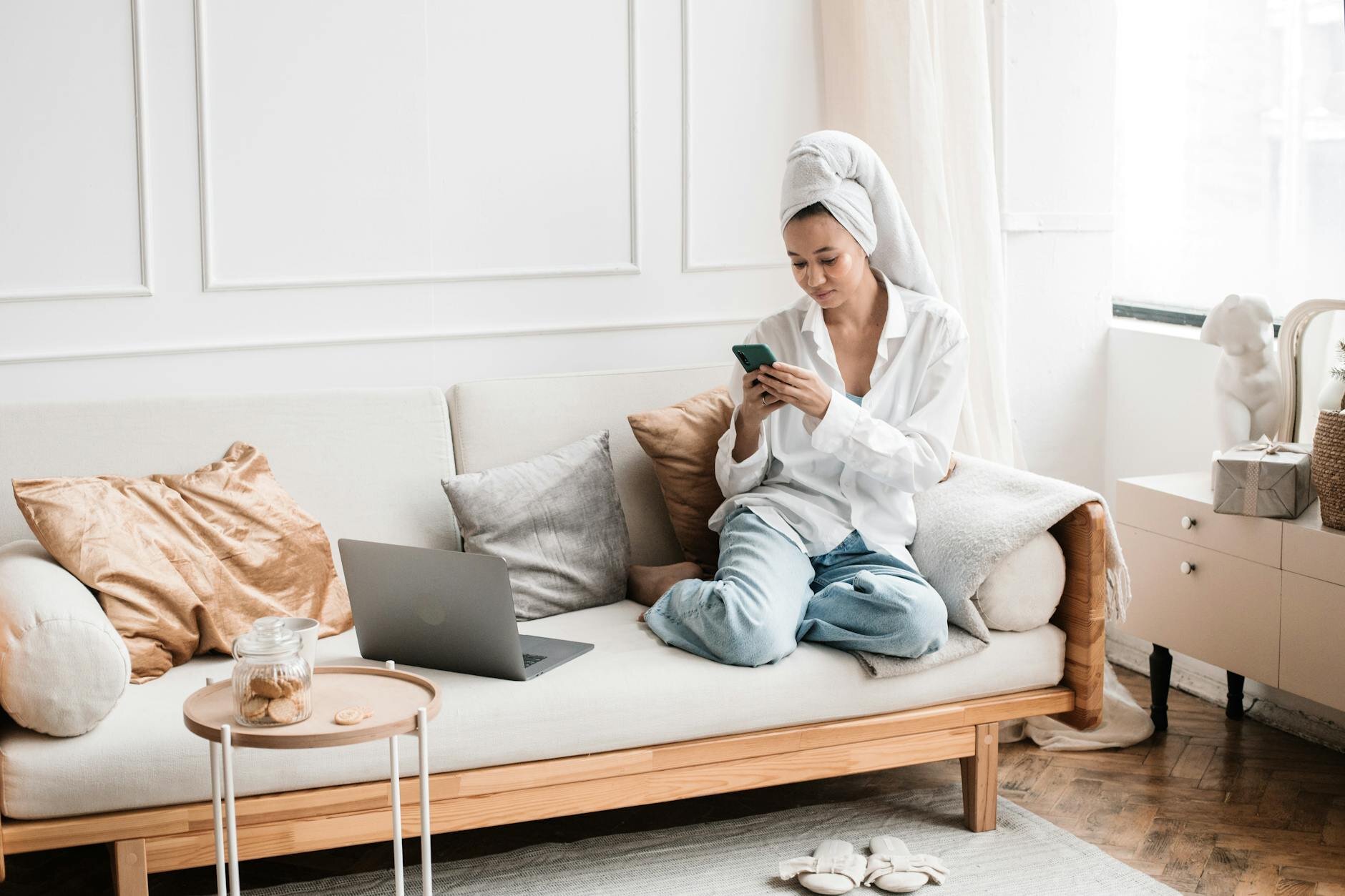 Woman sitting on couch of her home researching everything she needs to know about interest-only HELOCs