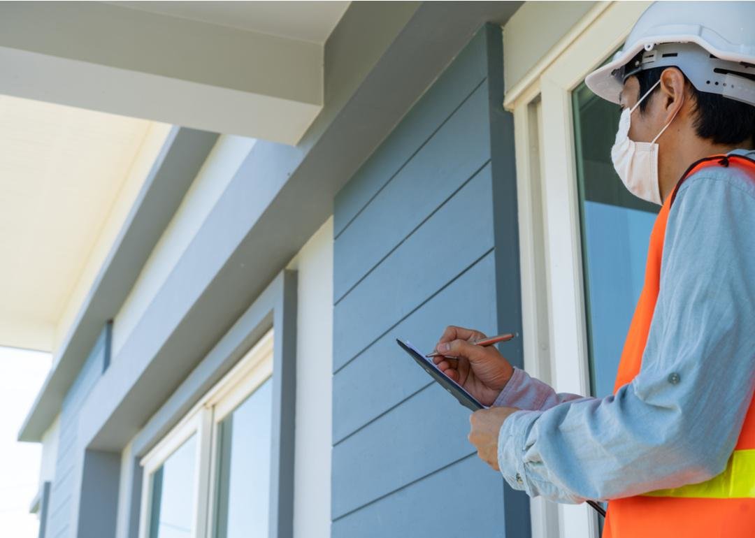  “Low-angle photograph of a home inspector inspecting a home” - Source: shisu_ka // Shutterstock