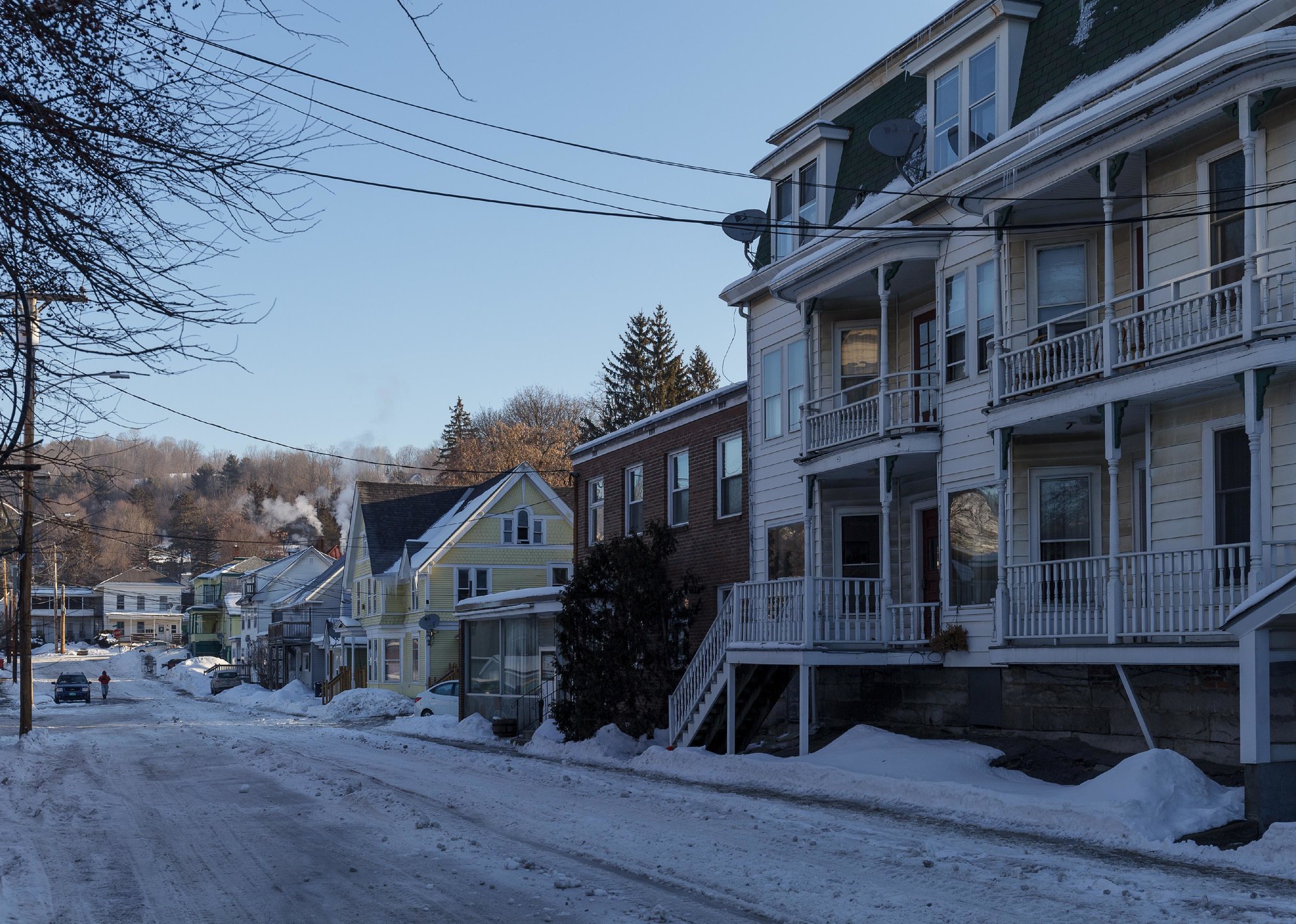  “Snowy residential street with three-story home in the foreground” - Source: yegorovnick // Shutterstock