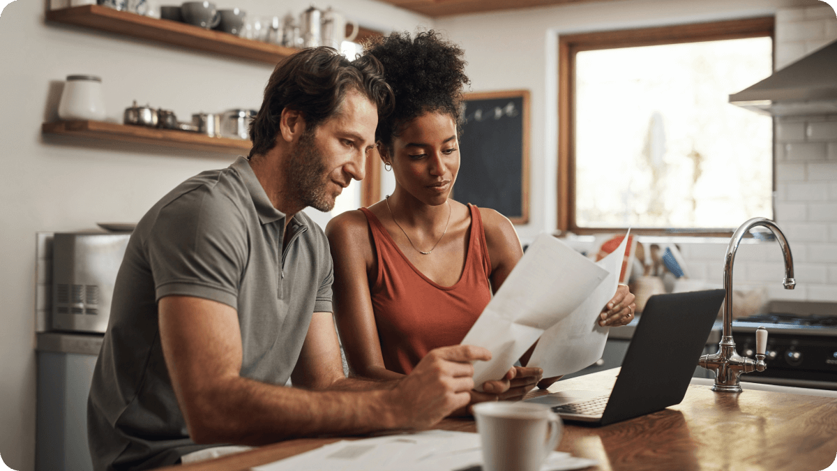 "Couple reviewing their mortgage pre approval letter'