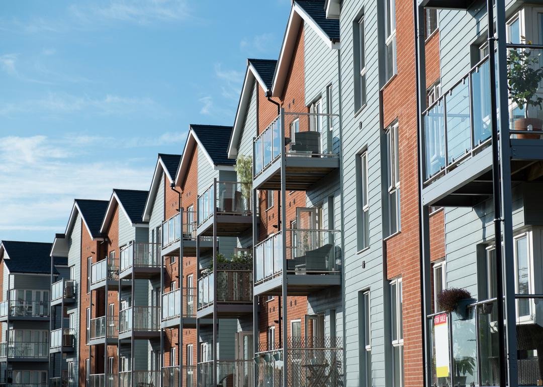 Row of two-tone condos with three-stories of balconies - Source: Smith Collection/Gado // Getty Images