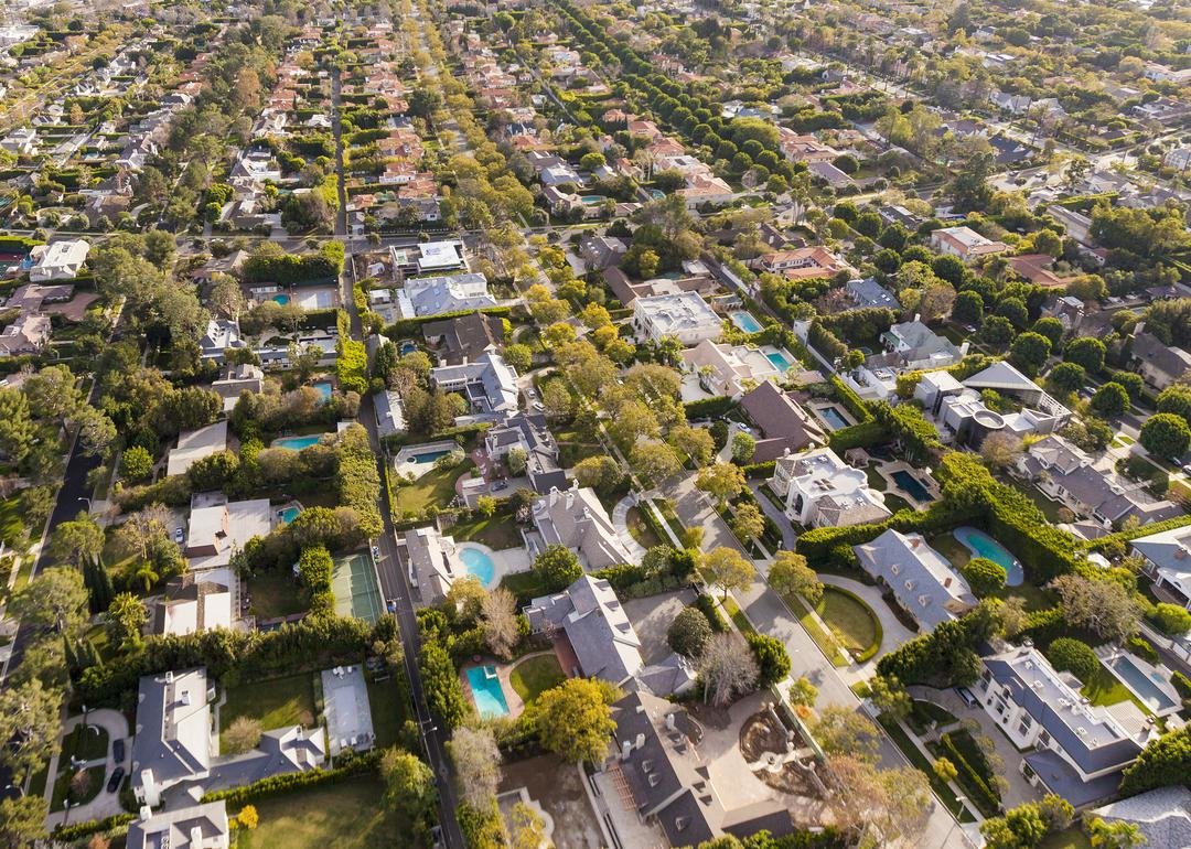 Zoomed out aerial shot of homes with skyscrapers in distance - Source: Sam Lafoca/Construction Photography/Avalon // Getty Images
