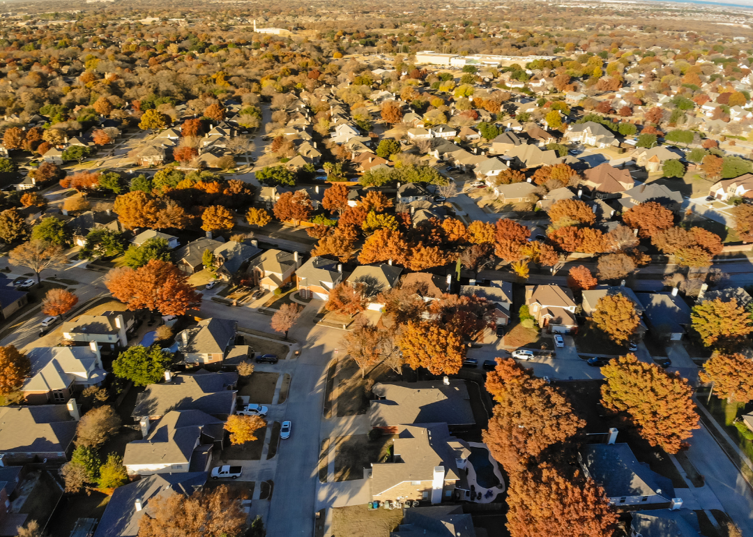 “Aerial photograph of a forested residential neighborhood” - Source: Canva