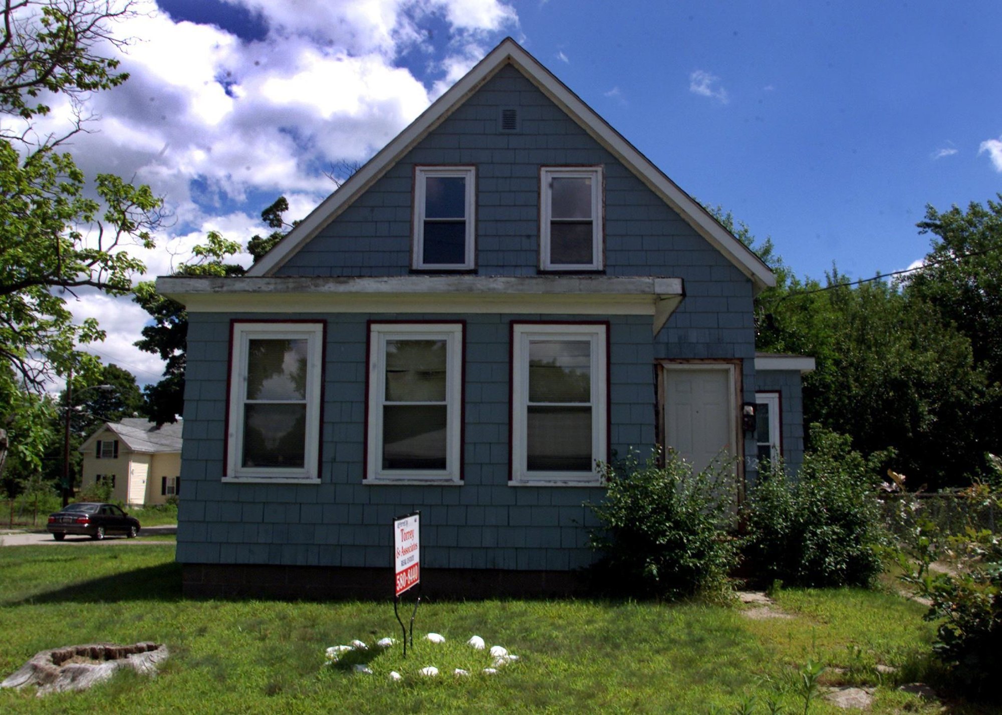 Two story corner home with unfinished gutter - Source: Barry Chin/The Boston Globe // Getty Images