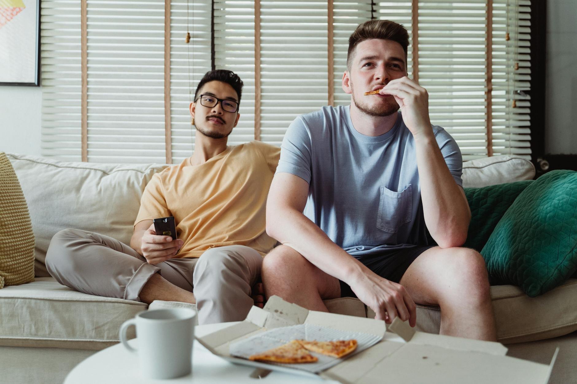 Two people watching the news to see how the Iran war is impacting mortgage rates