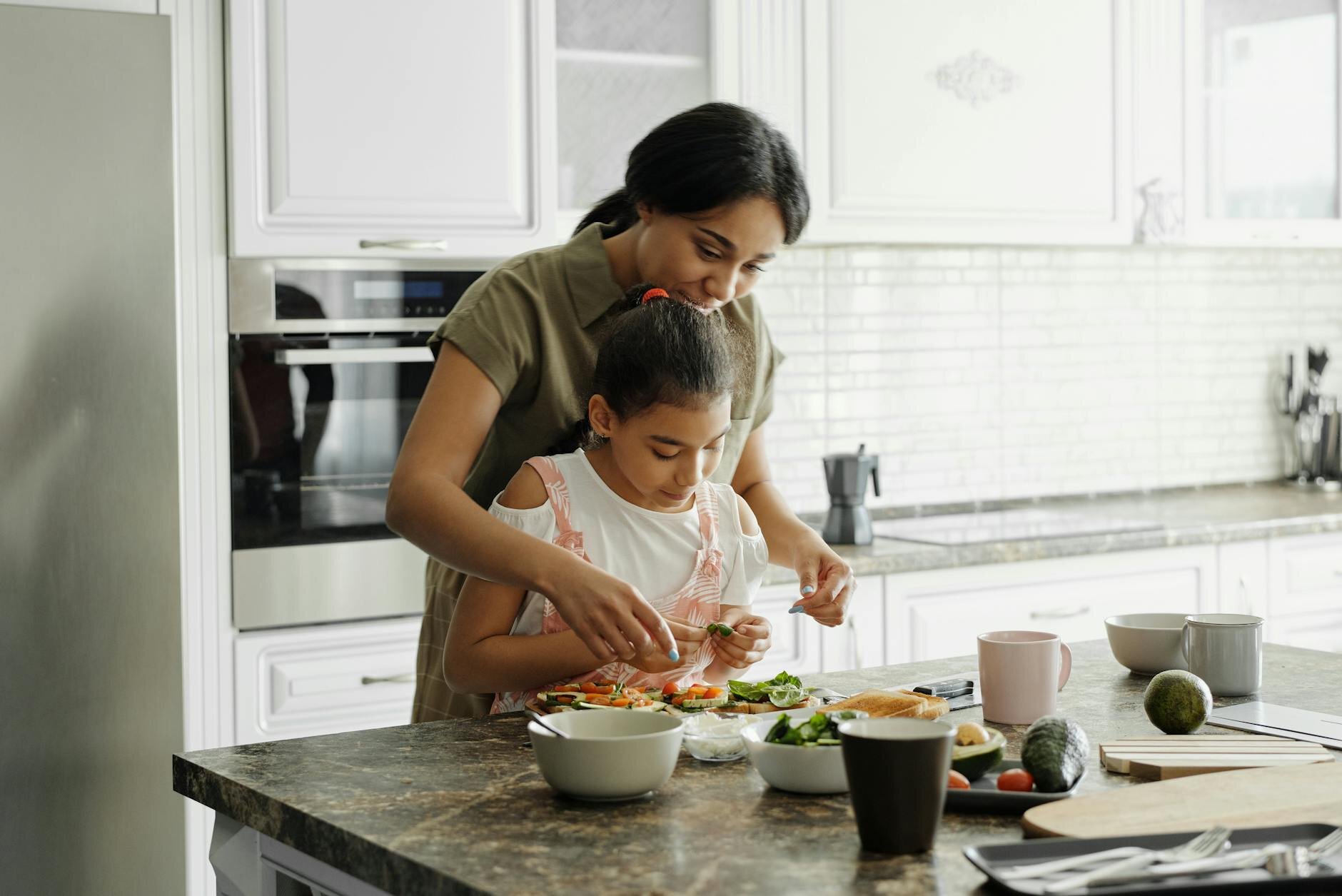 A mother and daughter in the kitchen of their home after purchasing it with a 10/1 ARM mortgage