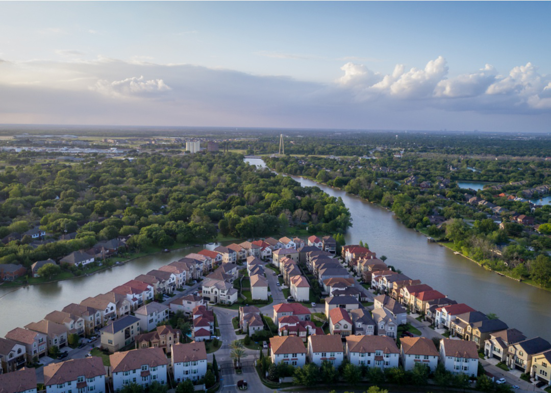 “Aerial photograph of a tightly-packed residential neighborhood built in the bend of a river” - Source: Kamil Zelezik // Shutterstock