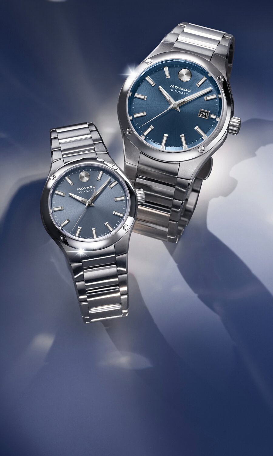 Museum Imperiale Men's watch with stainless steel bracelet and blue dial next to a Museum Imperiale Women's watch with stainless steel bracelet and blue dial.