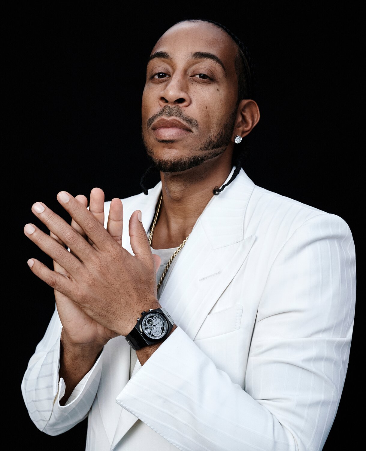 Ludacris in a white suit wearing a black BOLD Quest Skeleton watch