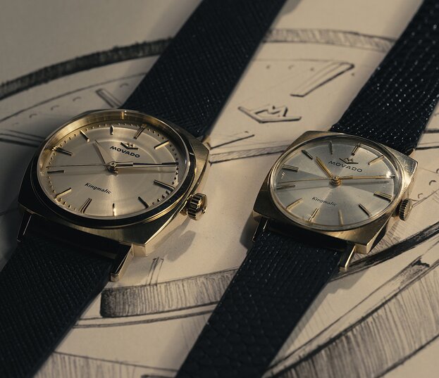 Original Heritage Kingmatic watch with black strap and gold square dial laying next to the new Heritage Kingmatic watch in the same color.