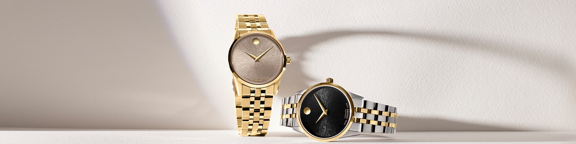 Museum Classic automatic bracelet watches in gold tone with taupe dial and two tone bracelet with black dial.