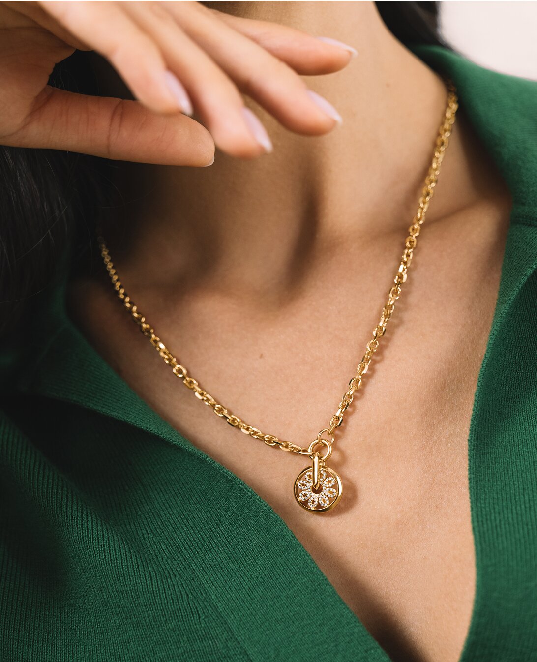 Woman in a green shirt wearing the gold tone Fleur necklace featuring lab grown diamonds