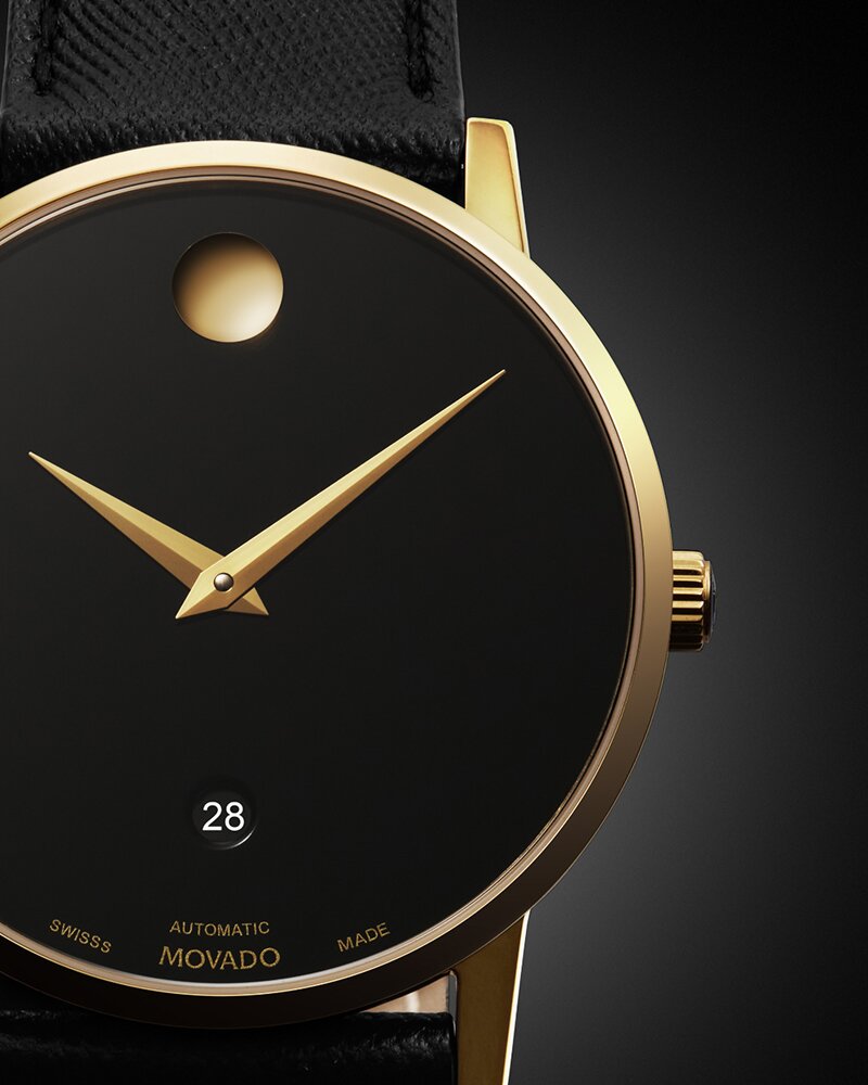 Close up of the Dial of the Museum Classic automatic watch with black strap and black dial with gold accents.