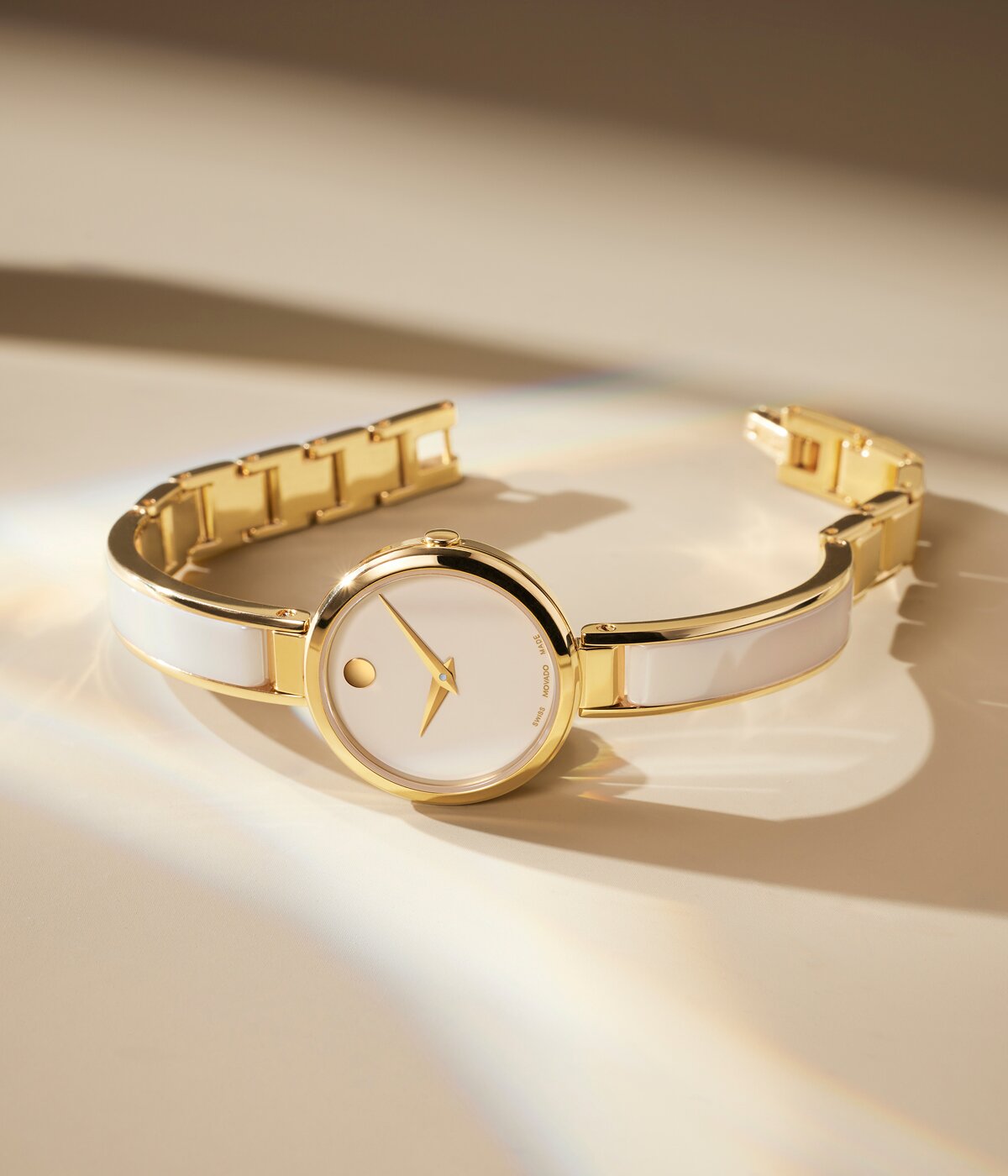 Champagne Moda Bangle watch laying on its side