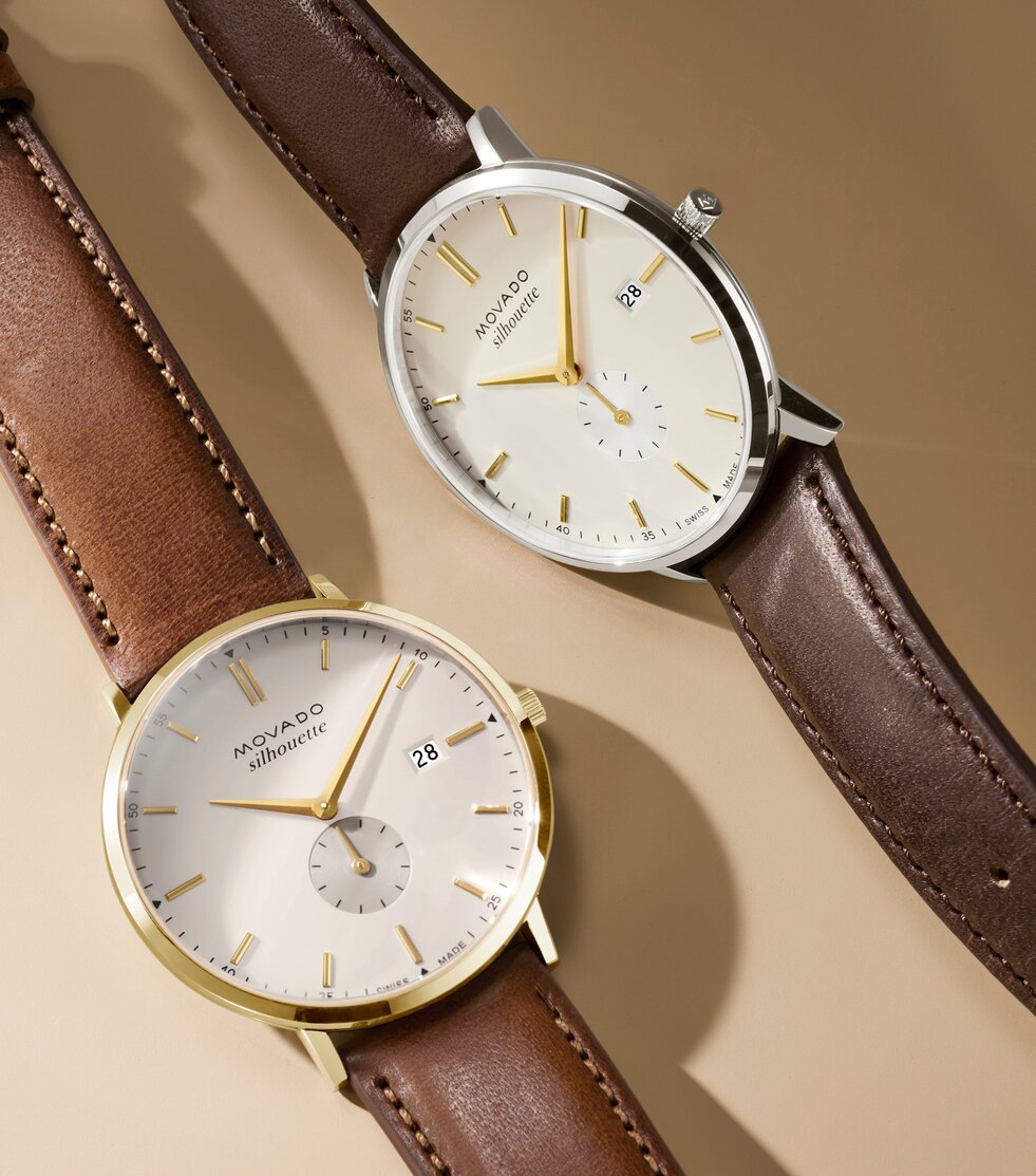Heritage Silhouette watch with light brown leather strap and white dial next to the Heritage Silhouette watch with dark brown leather strap and white dial.