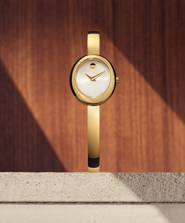 Gold tone Museum Bangle watch with white oval dial.
