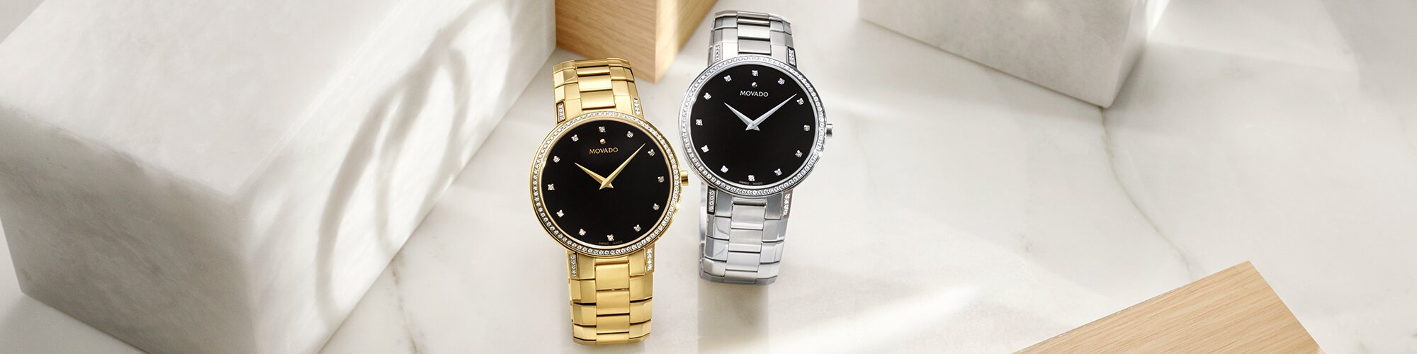 Gold tone Faceto bracelet watch with black dial and diamonds next to a silver Faceto bracelet watch with black dial and diamonds