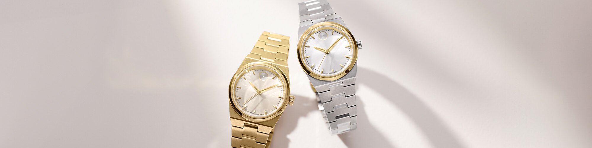 Gold tone BOLD Quest Mini watch next to silver BOLD Quest mini watch with gold tone accent.
