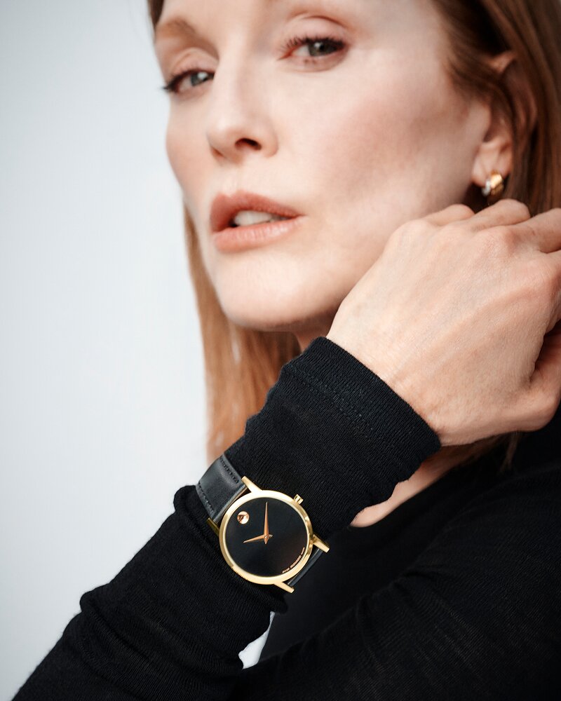 Julianne Moore wearing a black long sleeve shirt and a black Museum Classic watch with leather strap