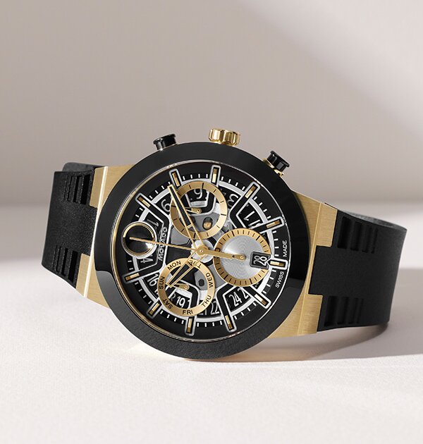BOLD Fusion watch with black rubber strap and silver and gold skeleton dial.