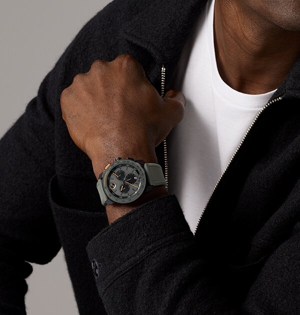 Man in a black jacket wearing a grey BOLD TR90 watch with rubber strap and black chronograph sub dials