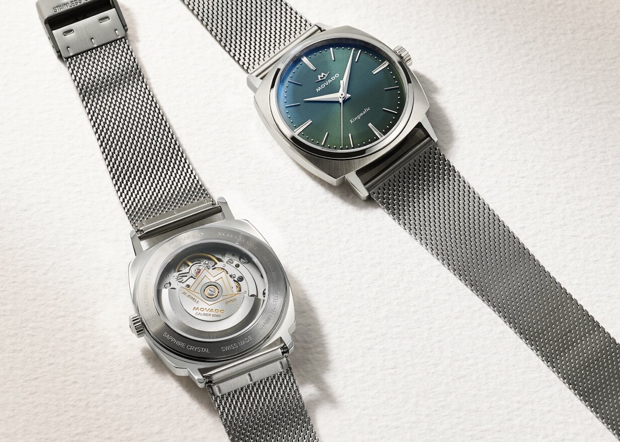 Heritage Kingmatic Automatic watch with stainless steel mesh bracelet and blue dial laying next to the back of the watch showcasing the exposed caseback.