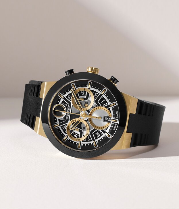 BOLD Fusion watch with black silicone strap and skeleton chronograph dial with gold tone and silver accents.