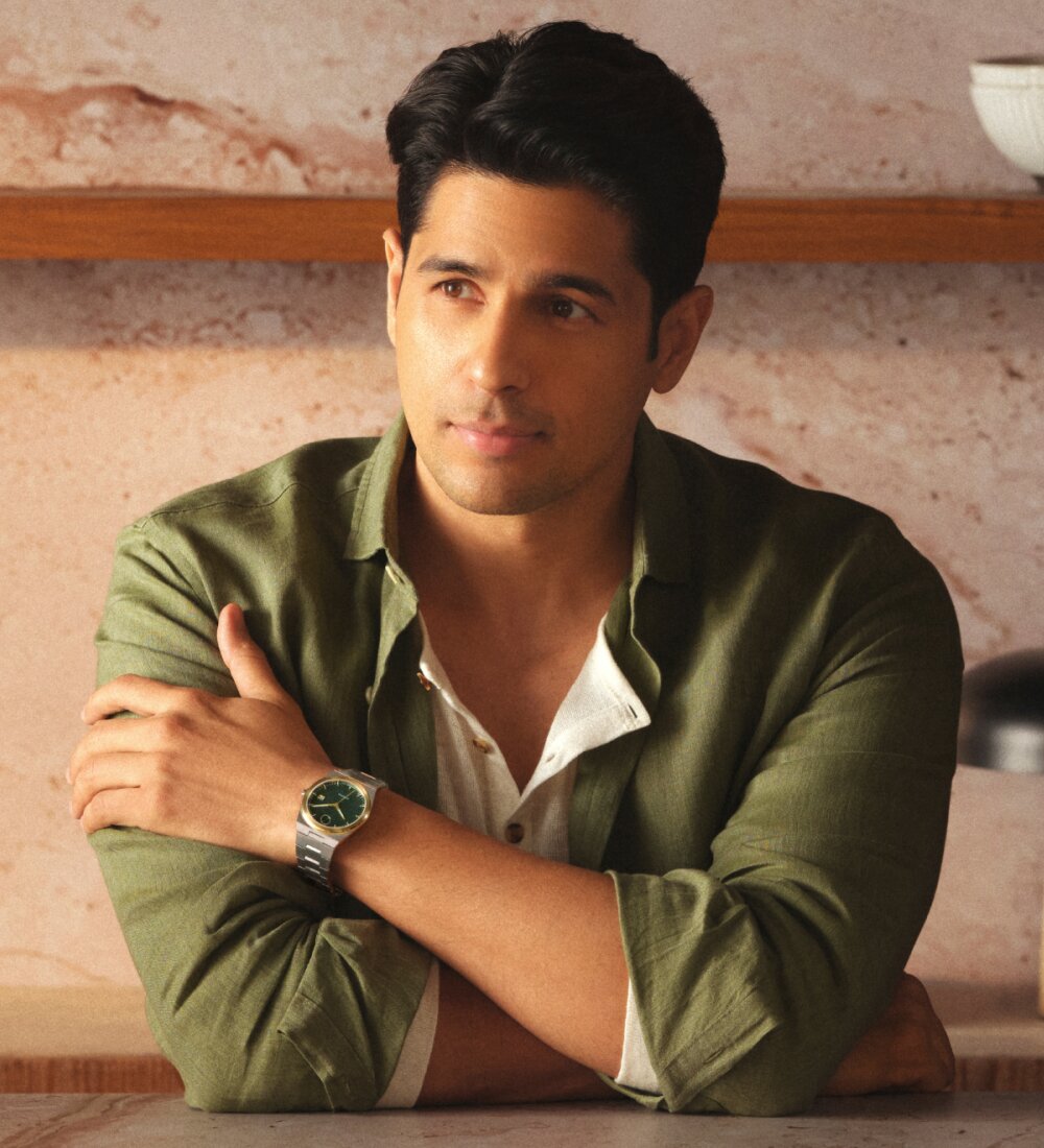 Sidharth Malhotra in a green button down wearing the BOLD Quest Automatic with stainless steel bracelet and green dial.