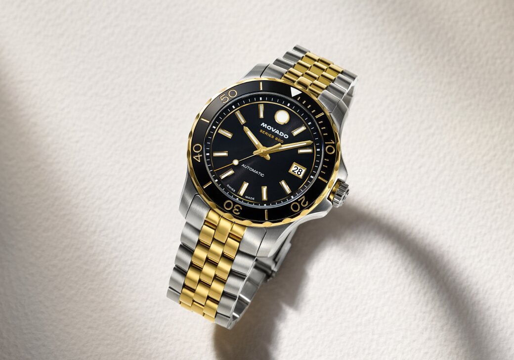 Two tone Series 800 bracelet watch with black dial.