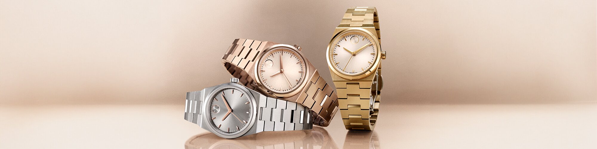 Silver BOLD Quest bracelet watch laying under a rose gold tone BOLD Quest bracelet watch with a gold tone BOLD Quest bracelet watch next to them